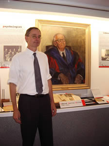 Richard Dearden, morris Miller Librarian in front of portrait of E.M.M.