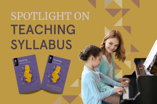 Smiling and encouraging teacher works with a young student at the piano.