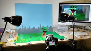 Creative workspace, animation scene with a character and trees with video and monitor.