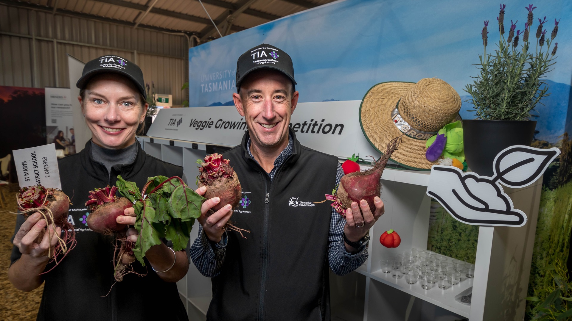 Two TIA staff holding beetroots