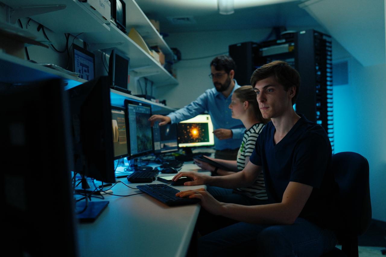 Astrophysics student Euan Hamdorf (foreground) at the controls of the Greenhill Observatory optical telescopes.