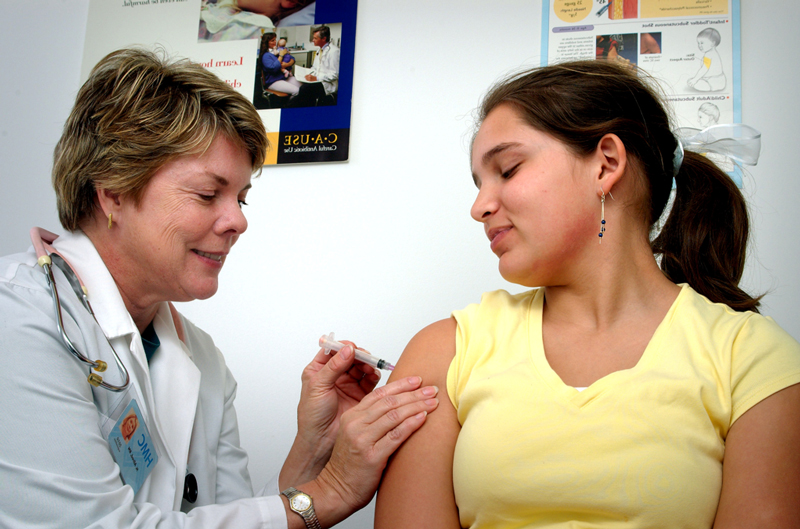 Doctor vaccinating woman