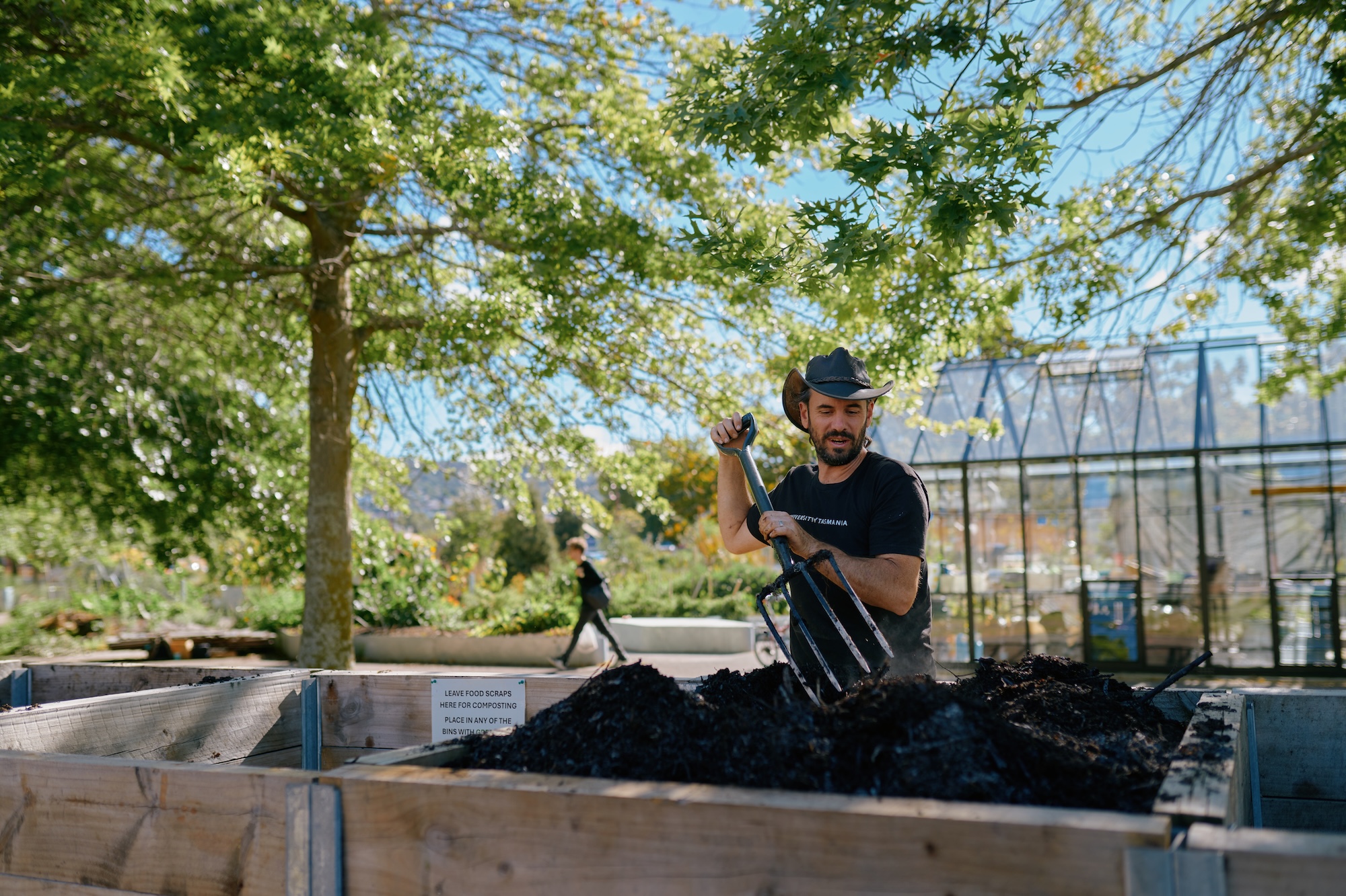 Sustainability north gardener Lars Roberts turns over a compost pile