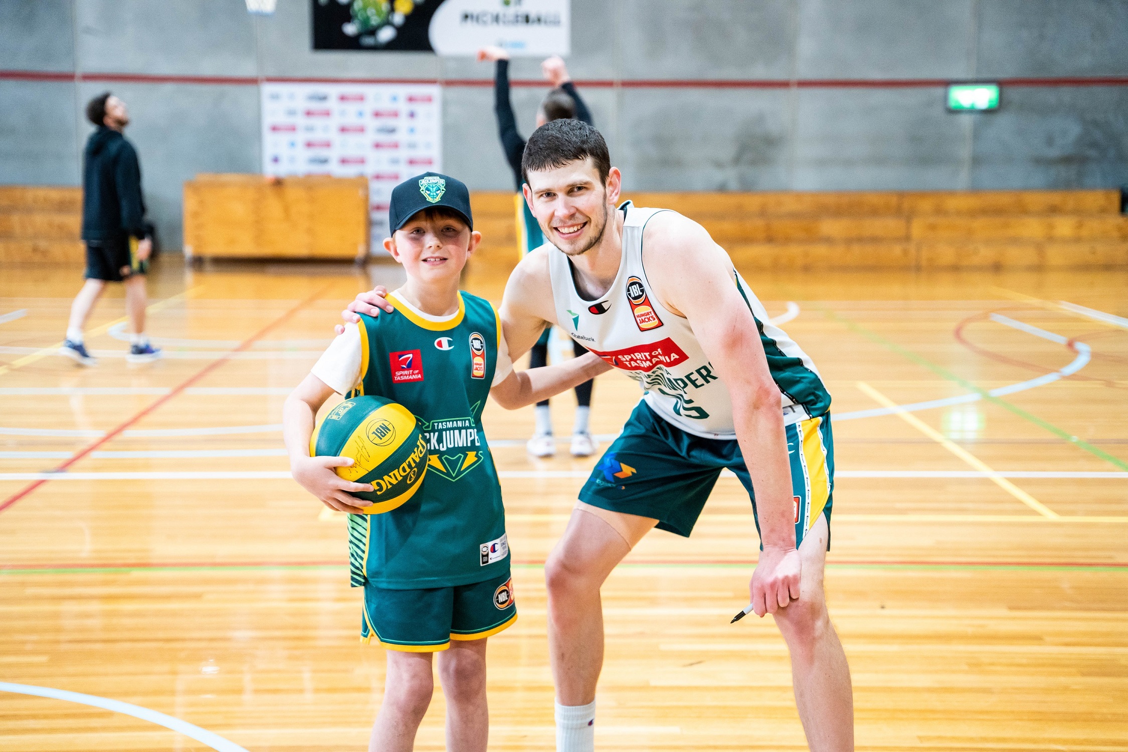 JackJumpers captain Clint Steindl with a young basketball fan. Clint is studying to be a secondary school teacher at the University of Tasmania. (Picture supplied by JackJumpers)