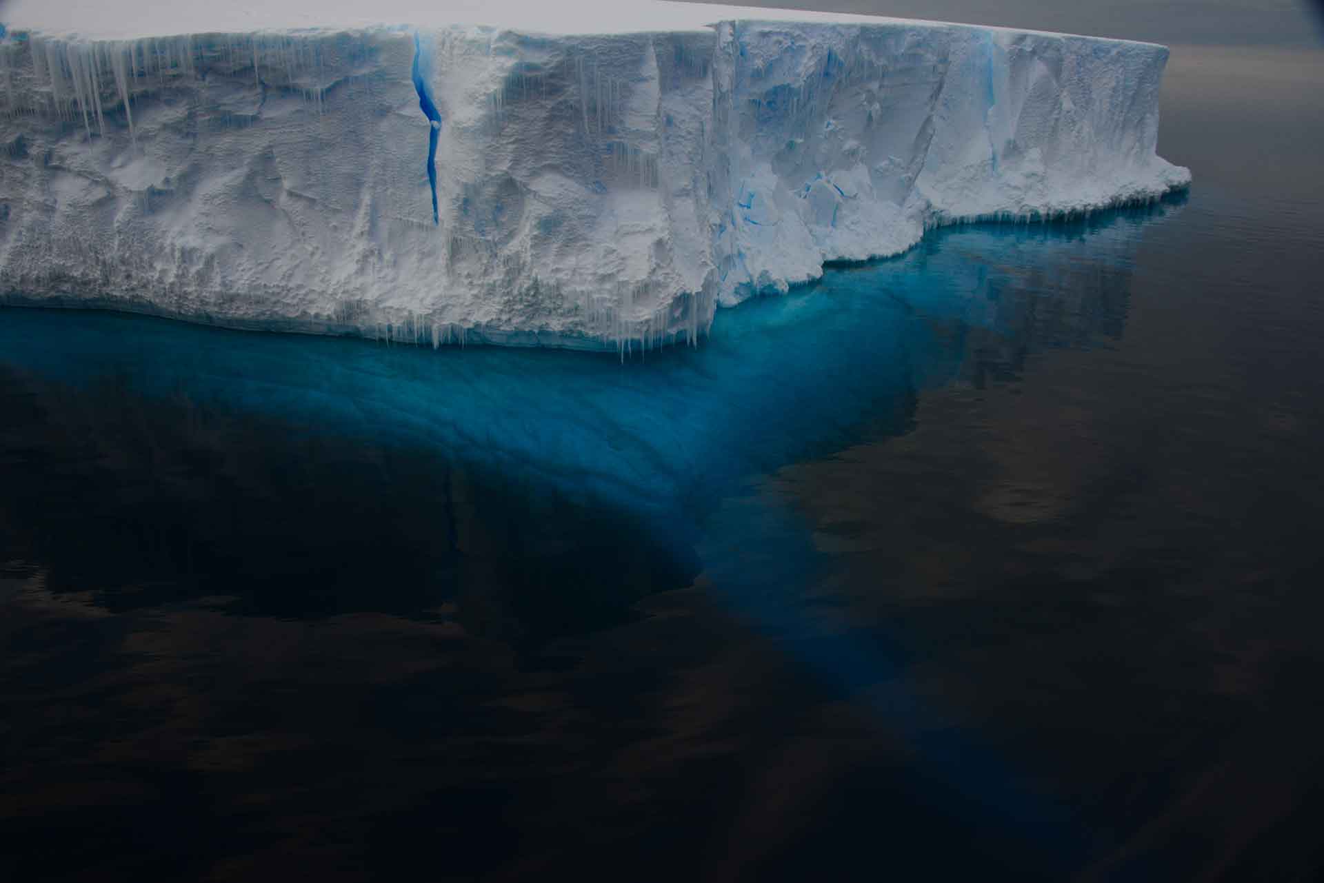 A massive iceberg showcasing both its above-water and submerged sections, illustrating the hidden depths beneath the surface.