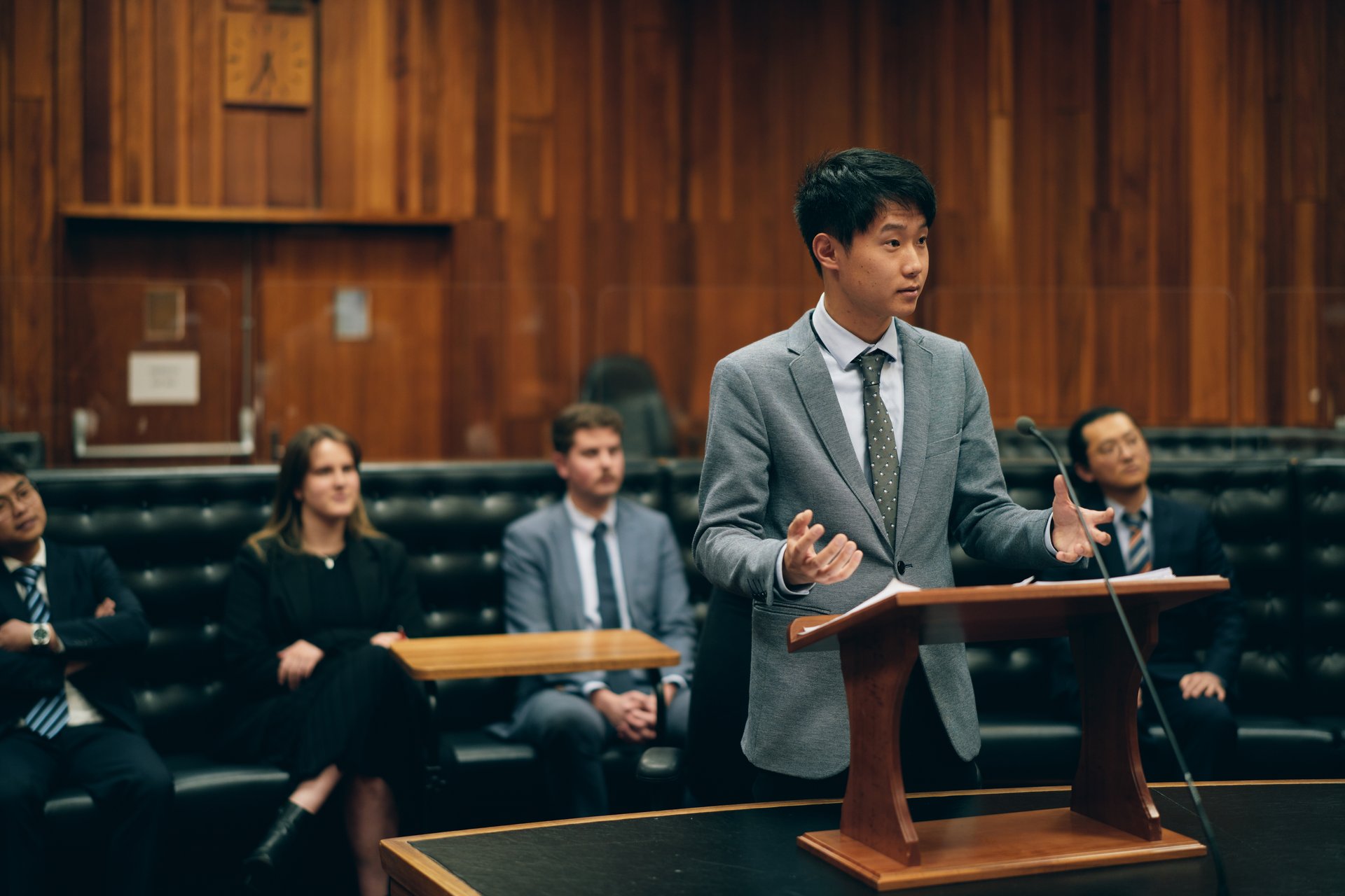 Man in a suit standing at a lectern in the Supreme Court of Tasmania