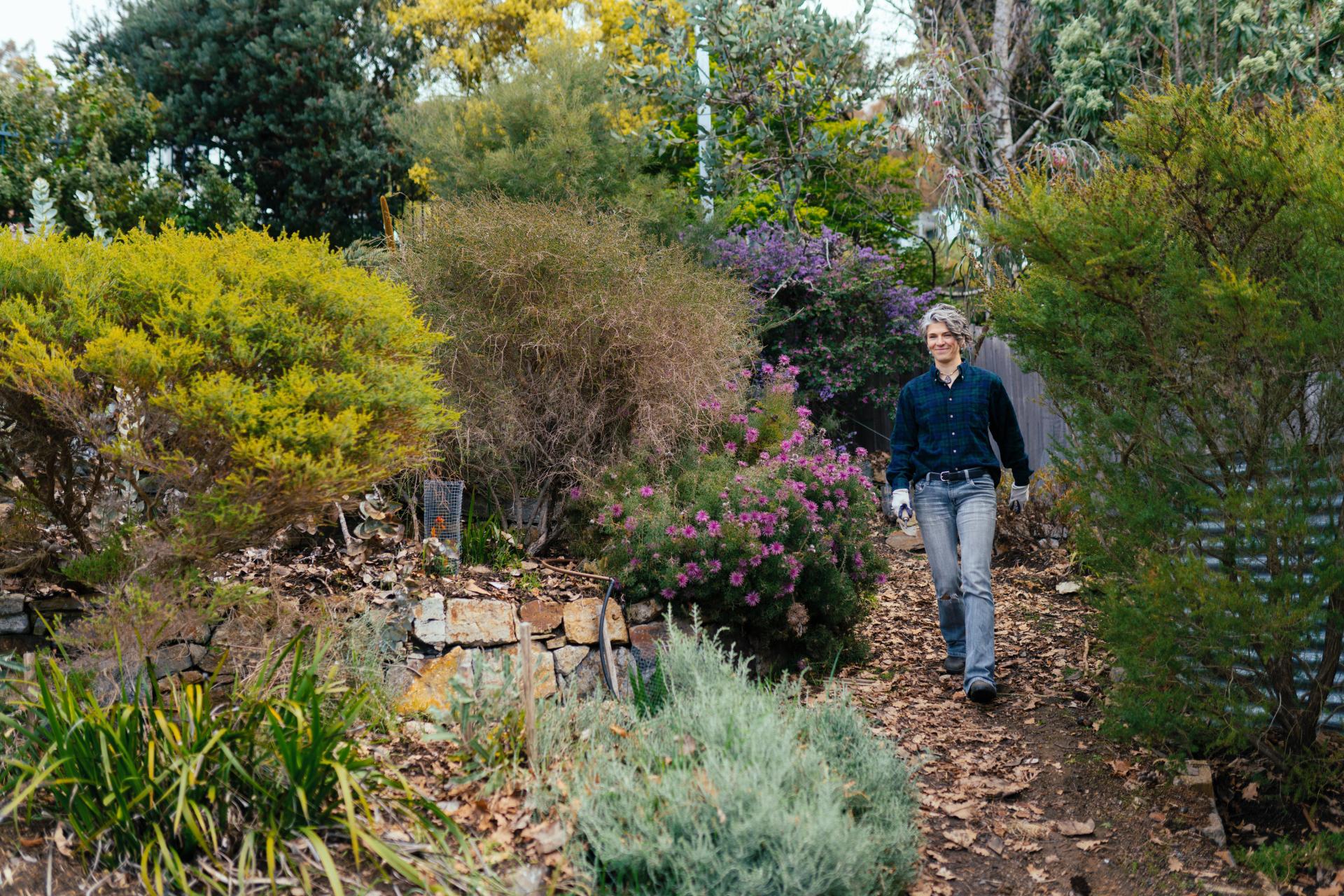 Dr Emily Flies walking through her backyard