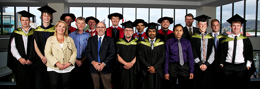 Group of 17 people in graduation gowns