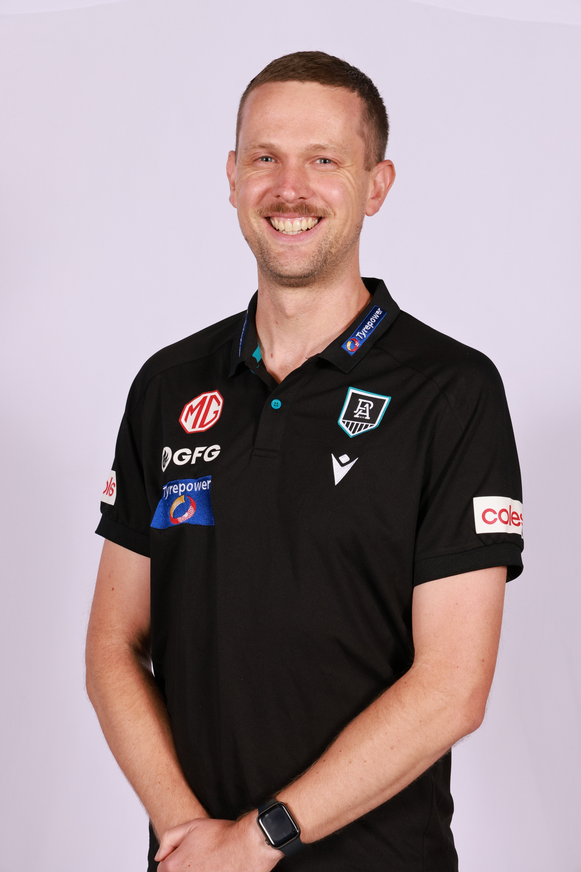A man standing in football coach apparel