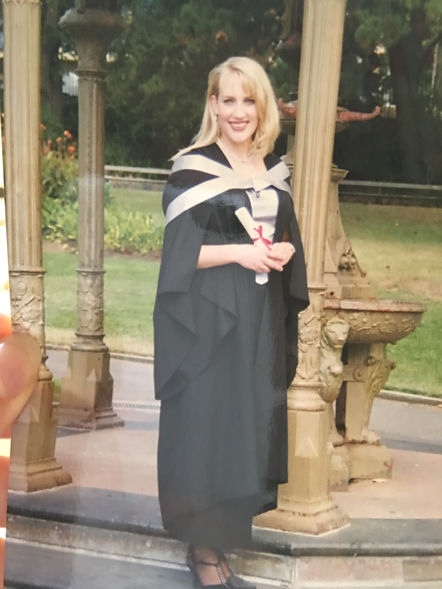 Emily Jade O'Keeffe graduates with her Bachelor of Performing Arts in Launceston in 1997, wearing her academic gown and hood (Picture: Emily Jade O’Keeffe)