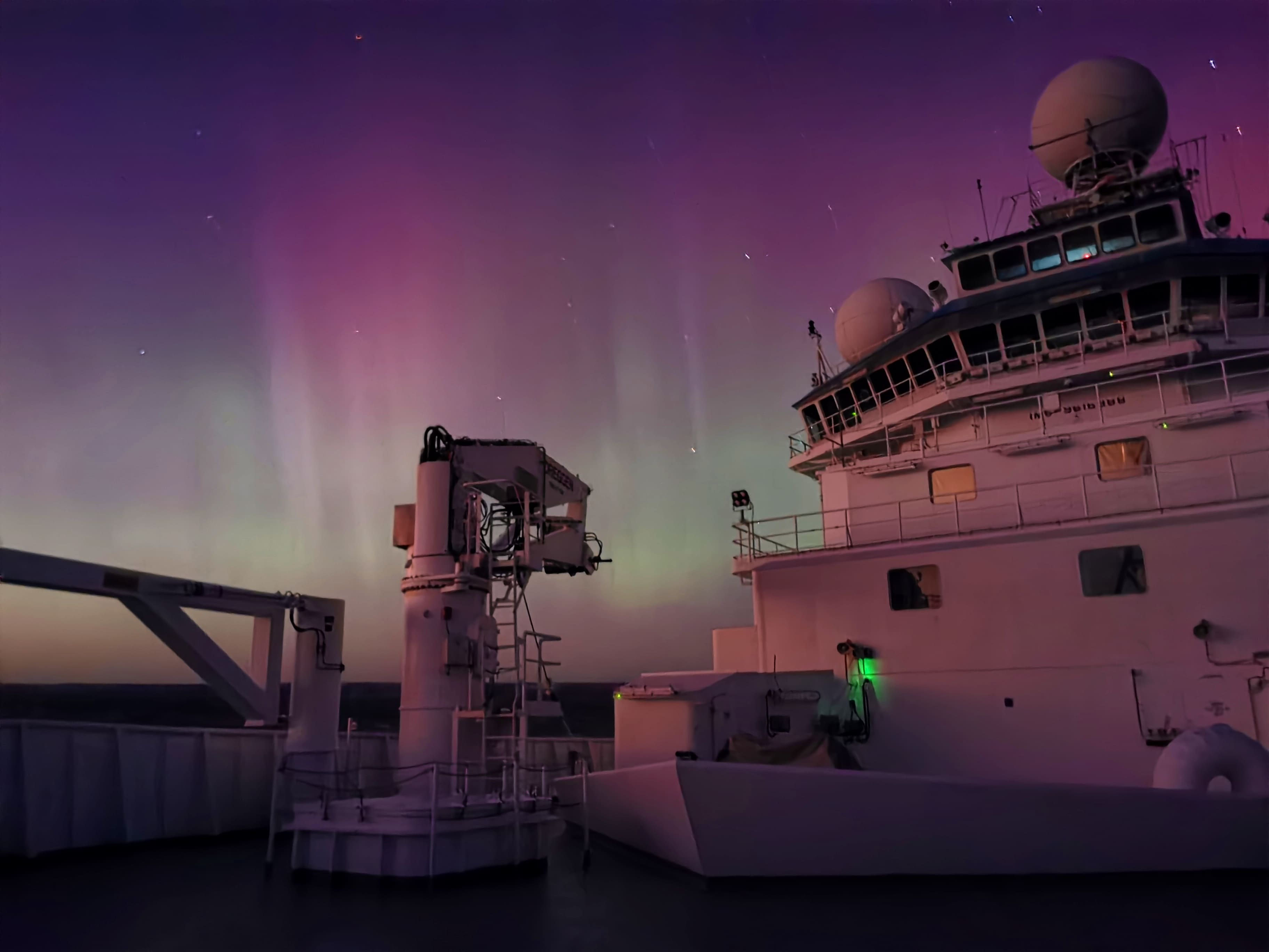 Purple and green sky caused by the Aurora Australis from the deck of the RV Investigator.