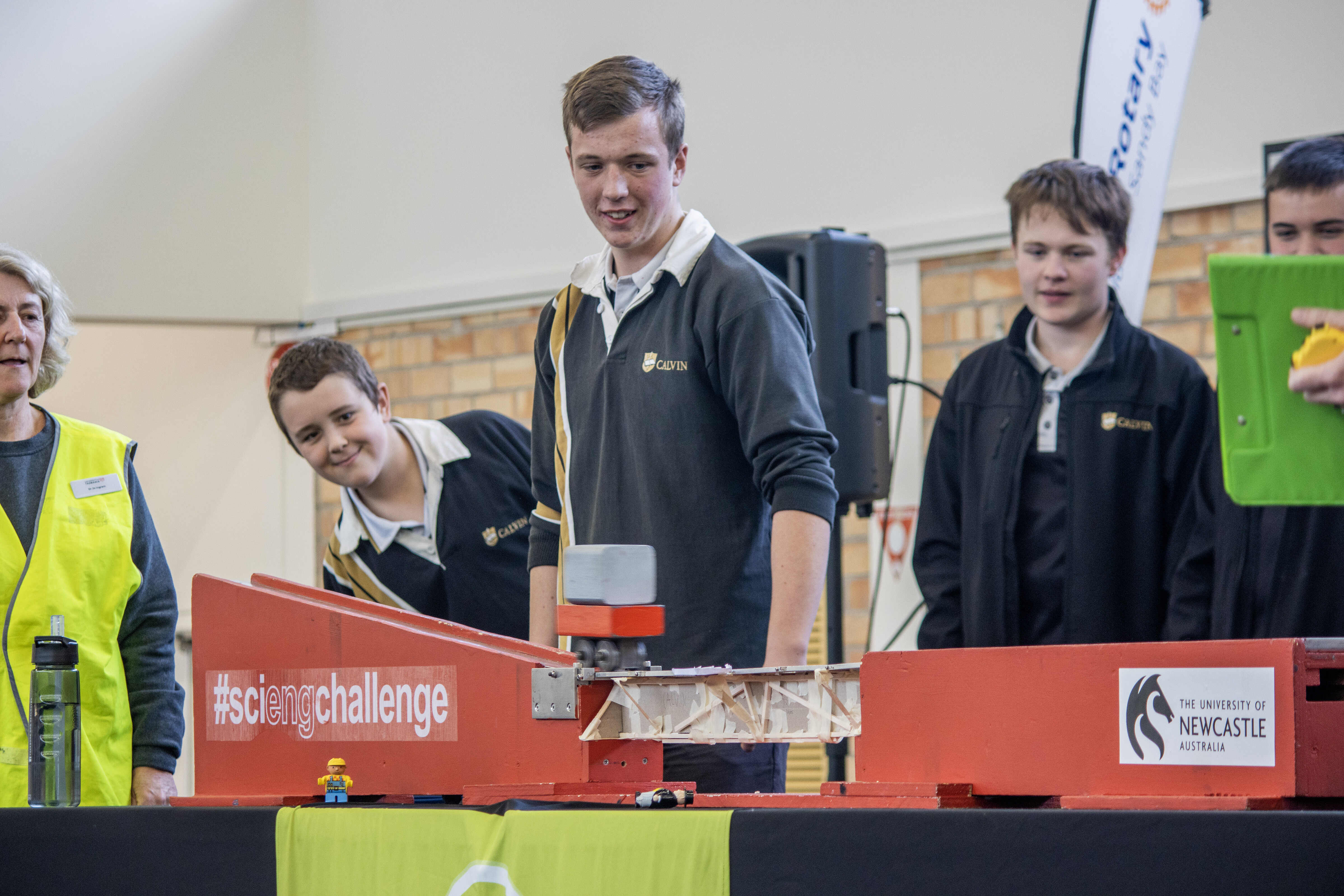 Students watch on as their bridge design is tested at the Science and Engineering Challenge