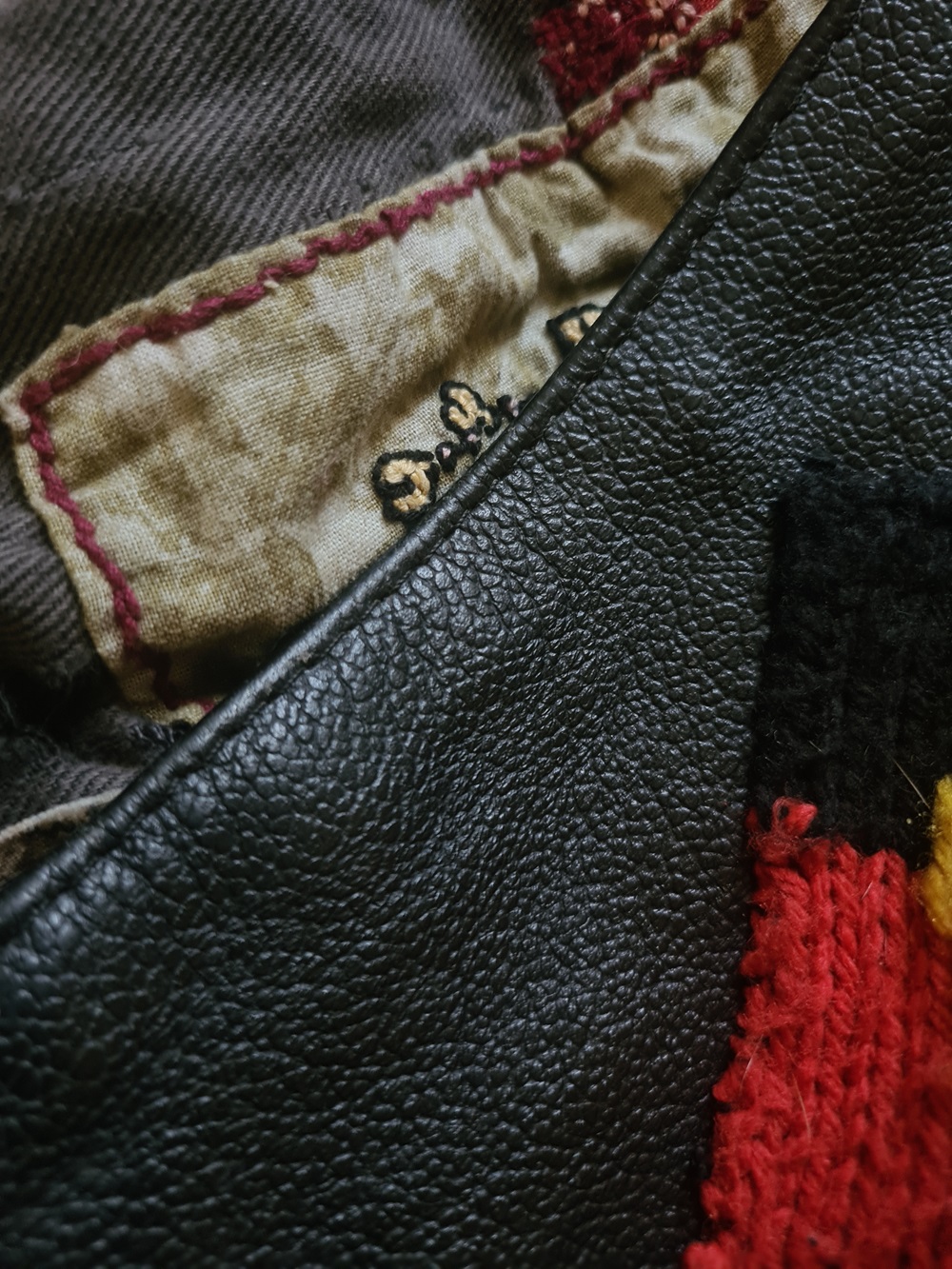 The image show details of fragments of the artist's fathers clothing including some hand sticked areas. 