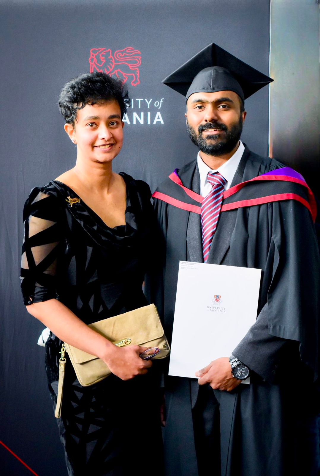 A portrait of Rakhitha and her husband at her husband's graduation.